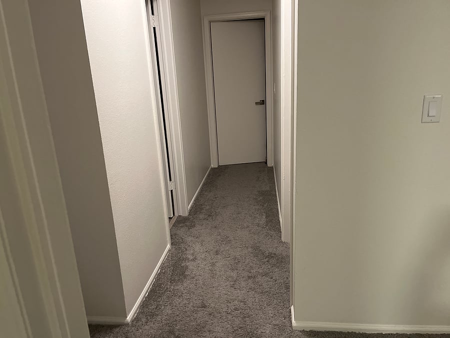 Hallway towards bath on left and master at end