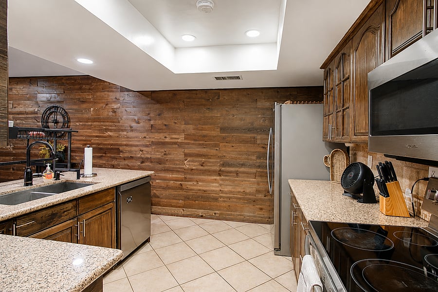 Experience a beautiful, rustic culinary space highlighted by a stunning wood-paneled accent wall.