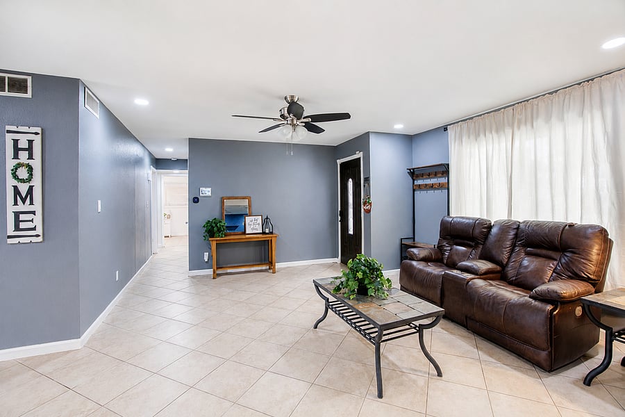 Relax on reclining leather seats in an open, airy living room designed for group comfort.