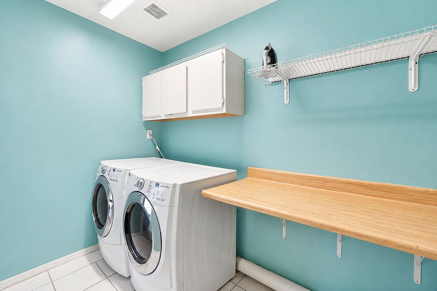 Enjoy the ultimate convenience of a private, dedicated laundry space stocked with built-in storage cabinets.
