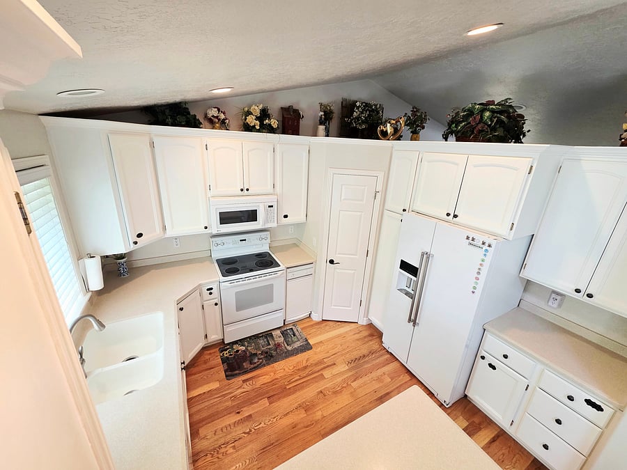 The kitchen is in the main floor and has full size fridge, large pantry, dishwasher, stove, microwave, and plenty of cabinet storage.