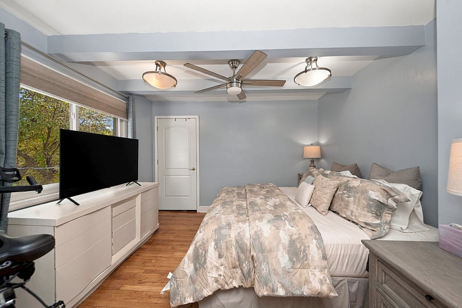 Master bedroom with 55 inch smart tv.