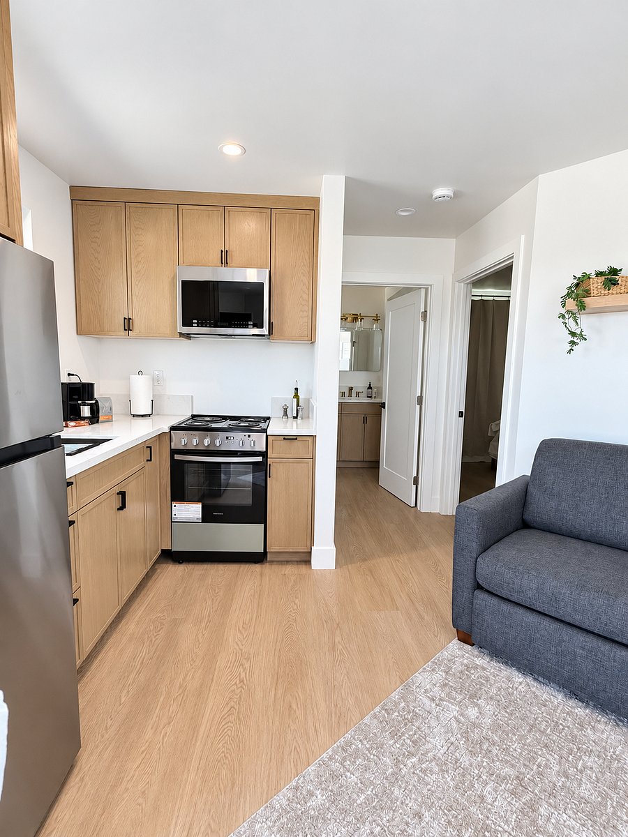 full kitchen with stove, microwave, fridge, coffee maker, full size sink and fully stocked kitchen