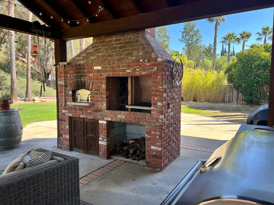 Argentine Rotisserie Grill with Pizza oven. Applewood provided.