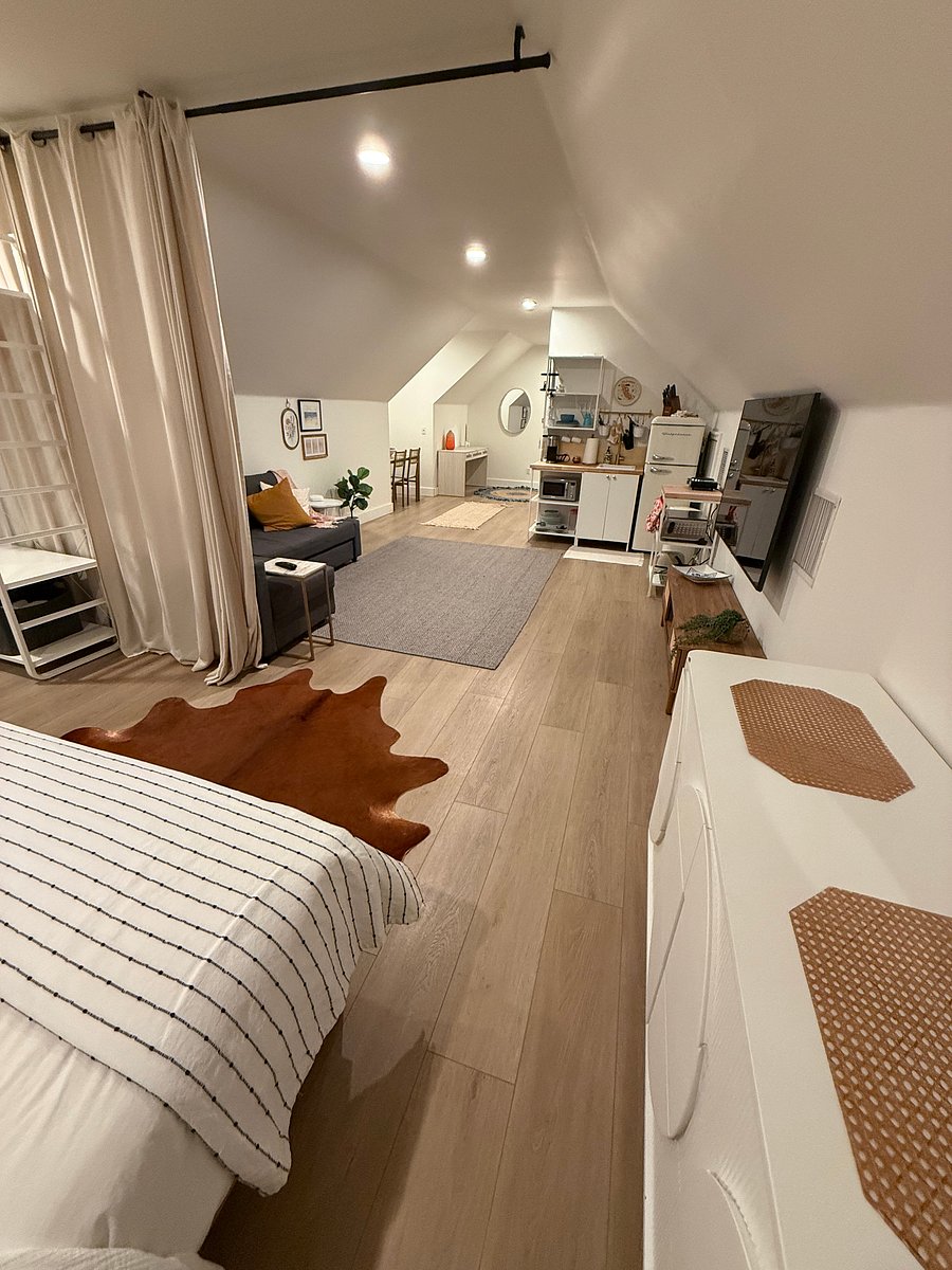 Looking across the stylish living area with a large TV from the sleeping area