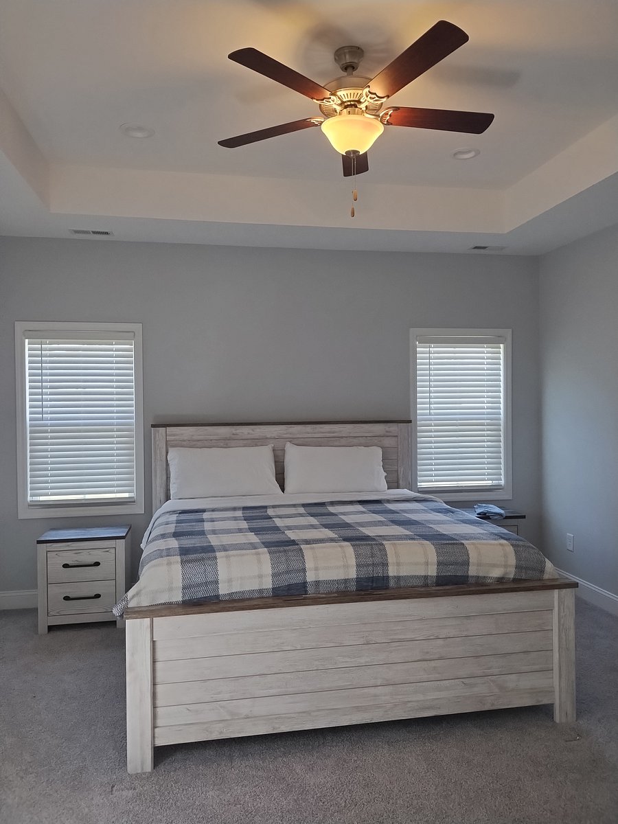 Master bedroom suite features a king sized bed, ceiling fan, large bathroom with shower & soaking tub as well as a large walk-in closet