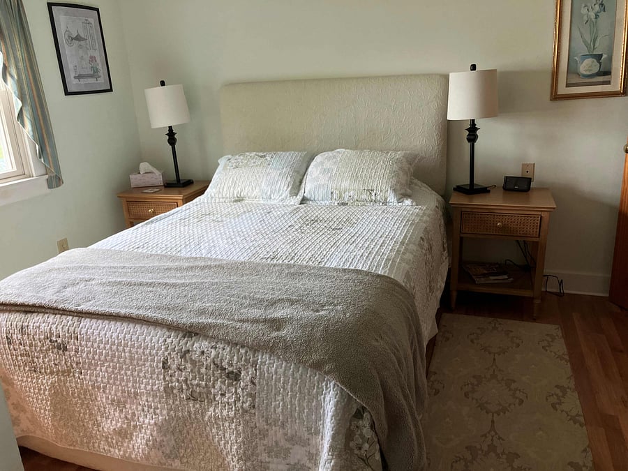 Primary bedroom with queen bed, bureau, closet and great view of the bay.