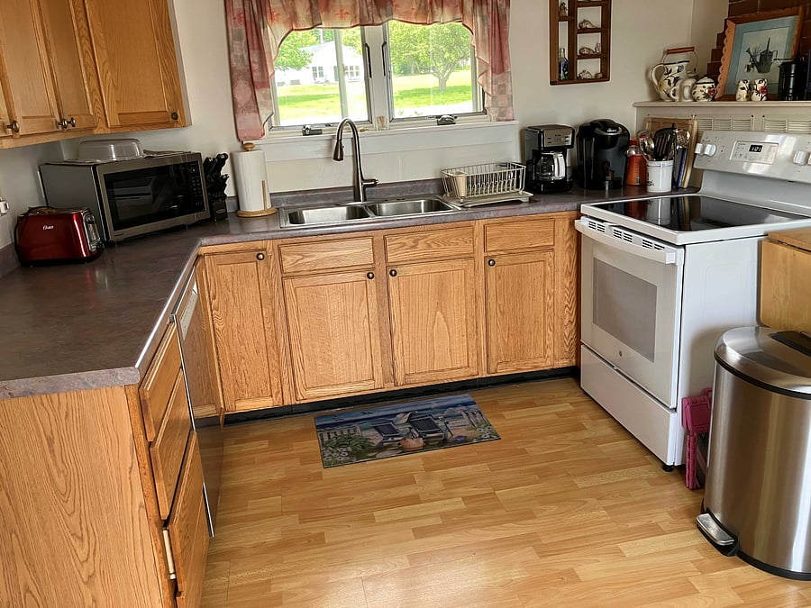 This kitchen is outfitted with everything you need. It has a microwave, dishwasher, electric glass topped range, coffee pot and single serve coffee maker, and toaster.