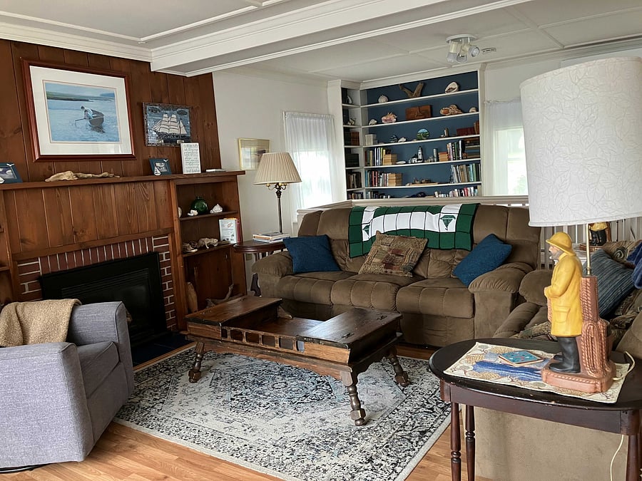 Living room with gas fireplace and book shelves of games and books.