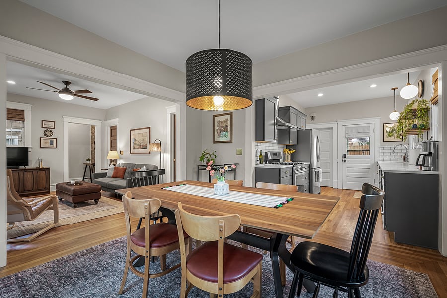 Spacious dining room for 6 people with open access to the kitchen for moving food, plates, etc. to and from or interacting with guests hanging out in the living room.