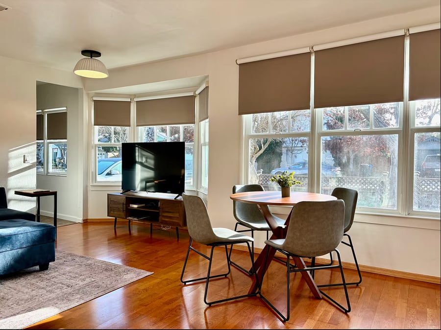 Living room with dining table, TV, and sofa