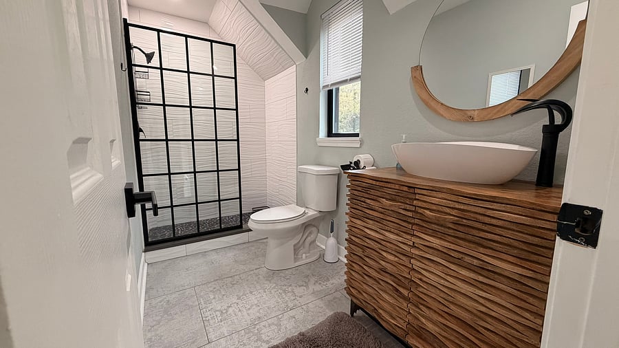 Spacious bathroom with walk in shower and tile surround. Fully equipped with towels, washcloths, hair dryer, first aid kit, etc.