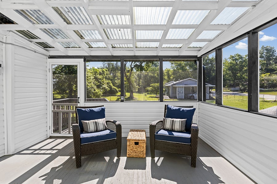 The spacious sun porch on the back of the home - is a great way to end the day! (This is also where the main entrance is to the dining area.)