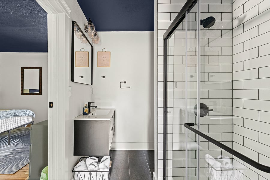 This remodeled full bath has a step in shower with glass door.
