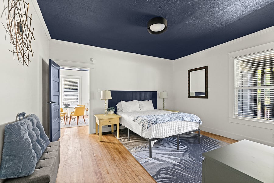 The primary bedroom is spacious with a window overlooking the front porch.