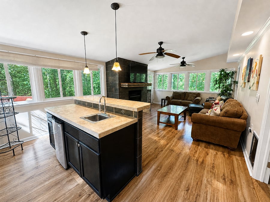 Sunroom with bar, mini fridge, and wood burning fireplace