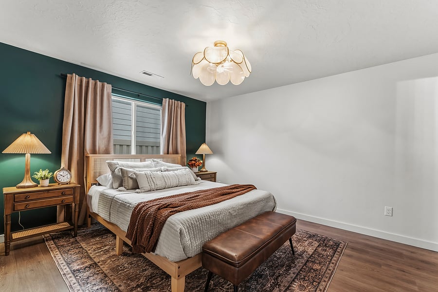 Primary bedroom with private en-suite. Queen bed with memory foam cooling mattress, extra linens, blackout curtains and storage in the ottoman at the end of the bed. 55" smart TV across from bed.