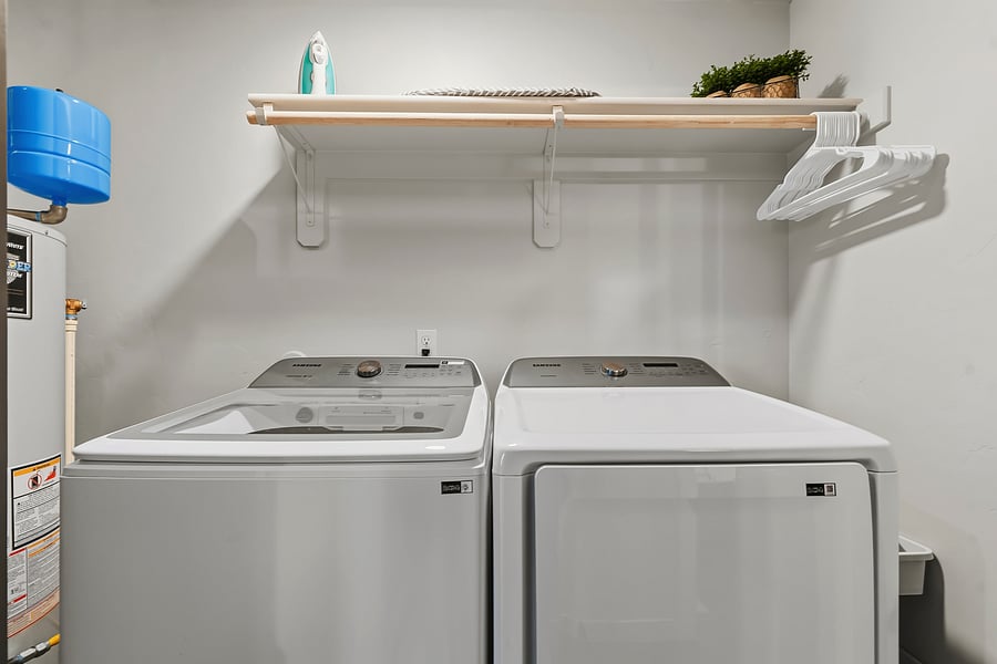 Laundry pods, stain remover, dry sheets, bleach, iron and board available for use.