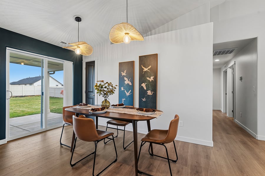Solid wood dining table for 4. Pantry space, access to backyard, and hallway leading to laundry, bathrooms and bedrooms