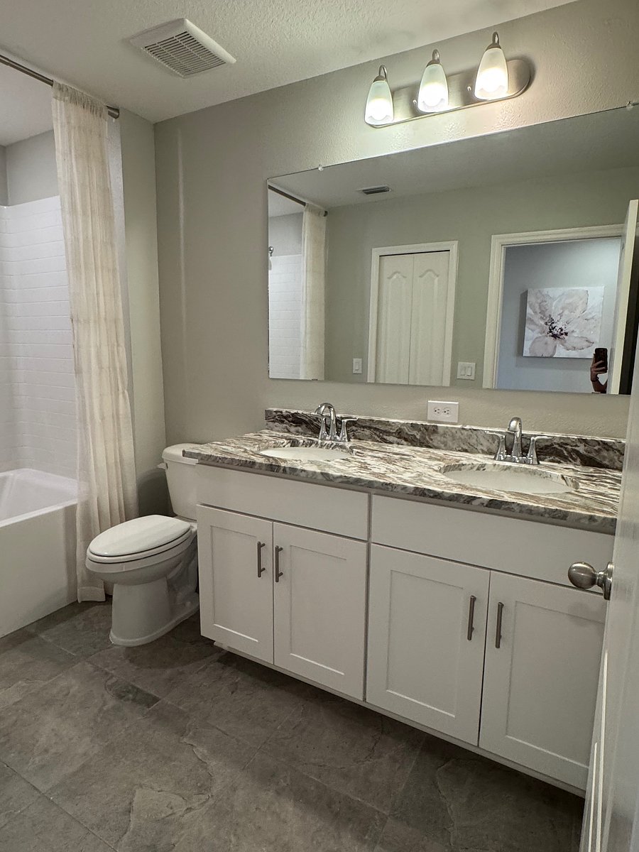 Secondary Bathroom with dual sinks and soaking tub