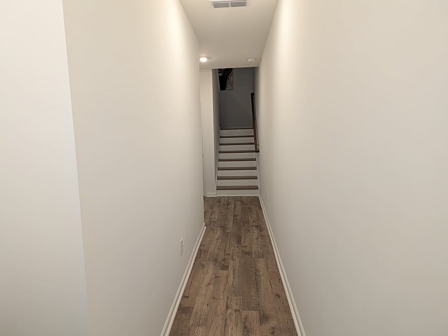Hallway inside front. entryway leading to guest suite. Stairs go up to second floor living room and main kitchen areas.