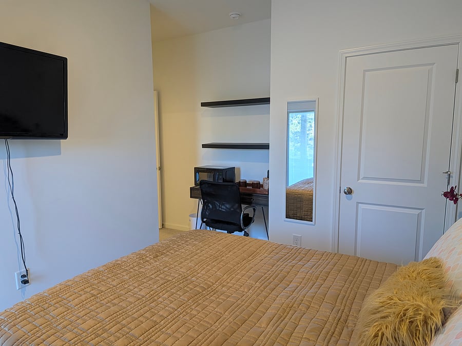 View to the desk area from the right side of the bed.