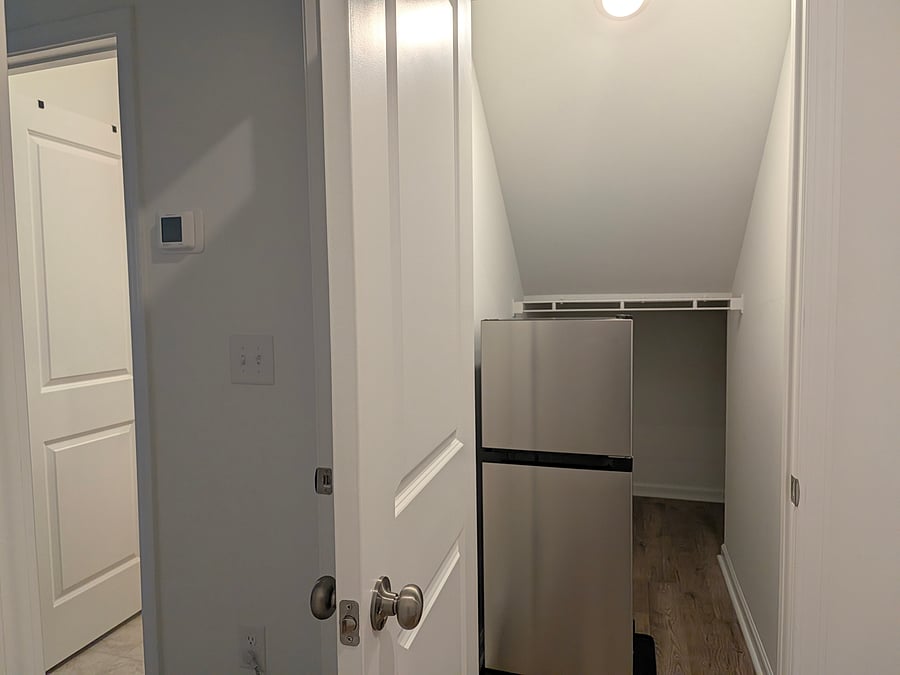 View of the overflow storage closet right outside the suite refrigerator for private use.