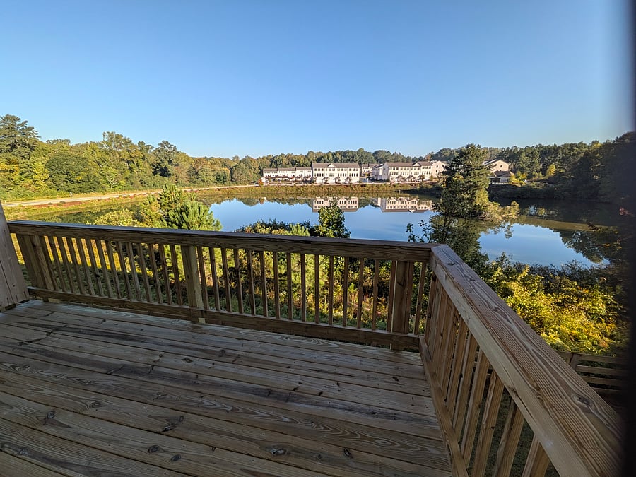 view to lake and community walking trail from kitchen deck