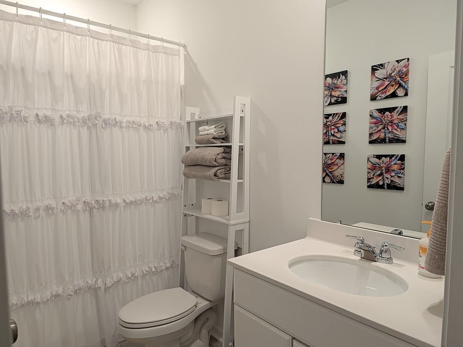 private bathroom with storage shelving