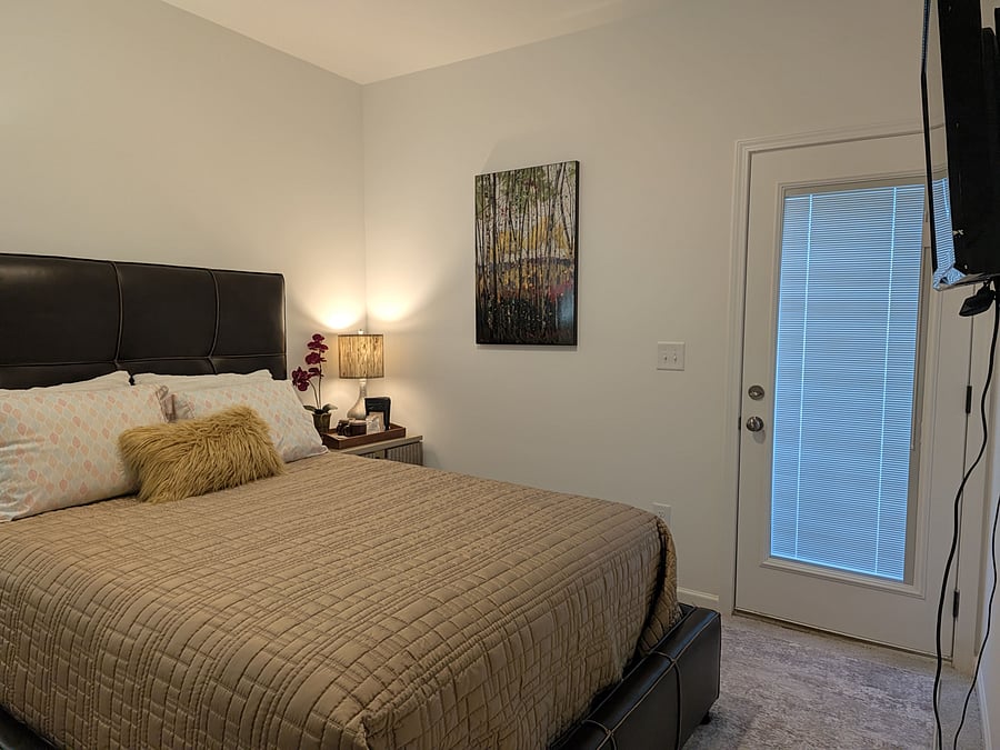 bedroom view with blinds closed and lights on.