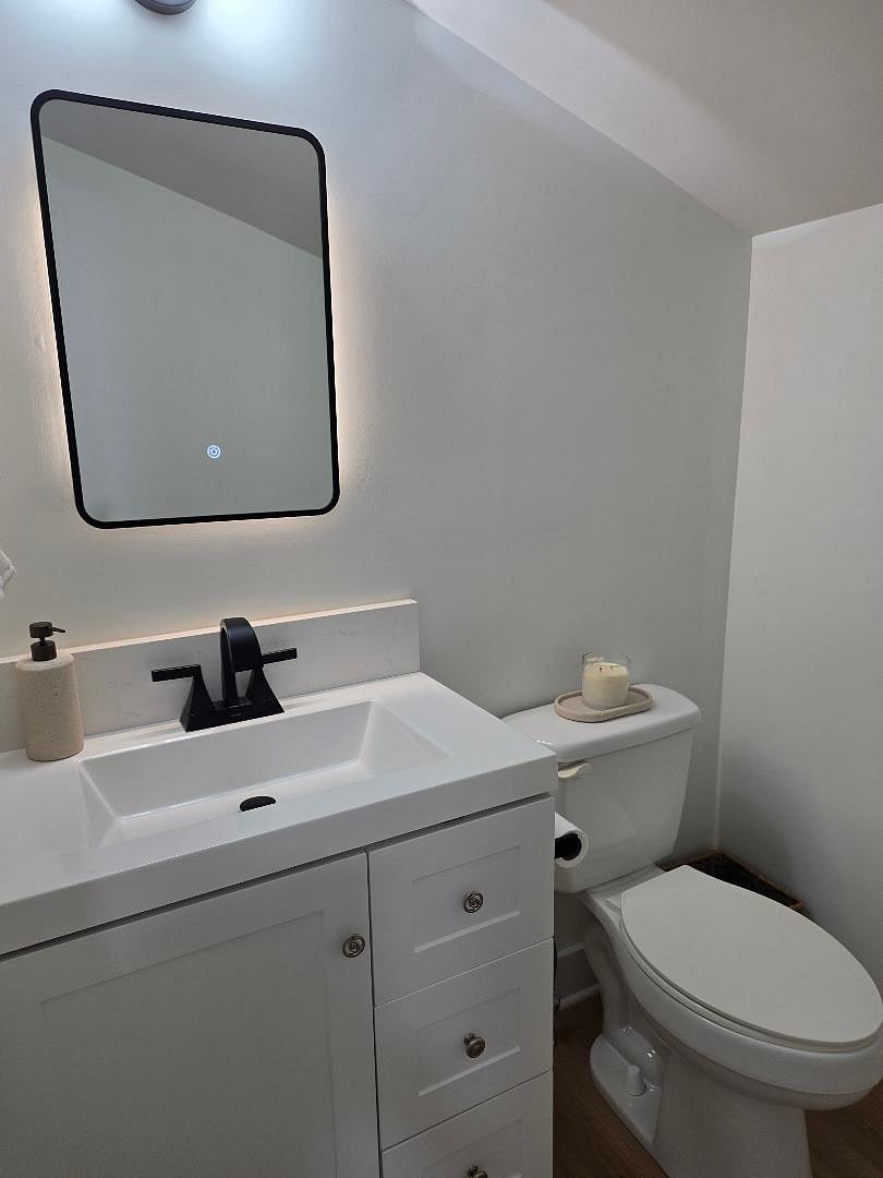 Separate water closet/sink with lighted mirror.