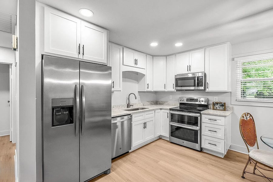 The kitchen has been updated with new appliances.