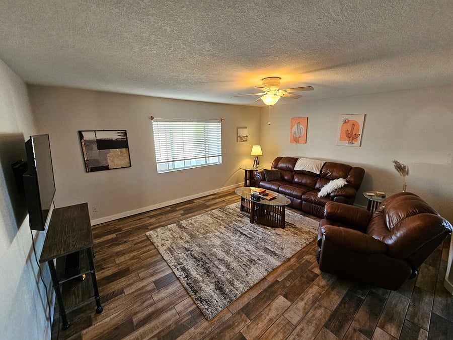 Family room. The sofa has built-in recliners on both ends. There is a premium Bose Soundbar connected to the smart TV, and easy connection to your phone's Bluetooth for your listening pleasure.