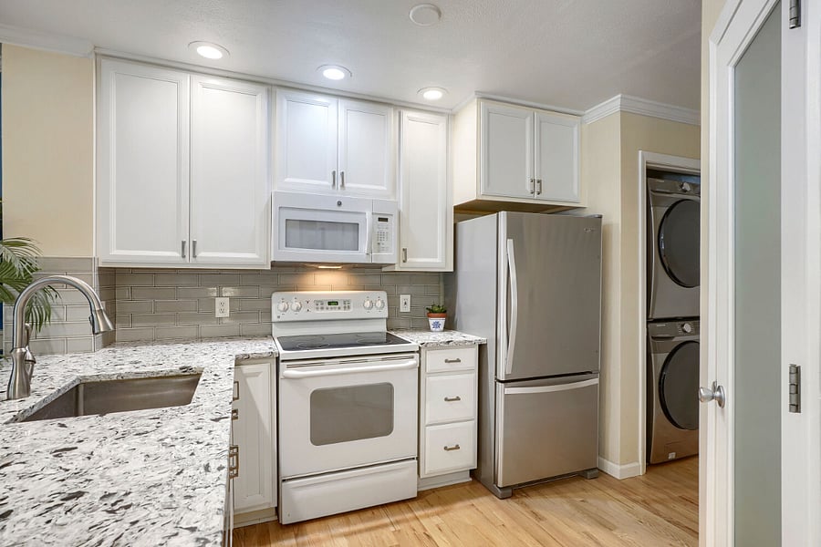 Fully Equipped Kitchen  A bright, functional kitchen featuring a full-size refrigerator, oven, and Bosch dishwasher. A coffee maker, blender, and toaster are also provided for added convenience.