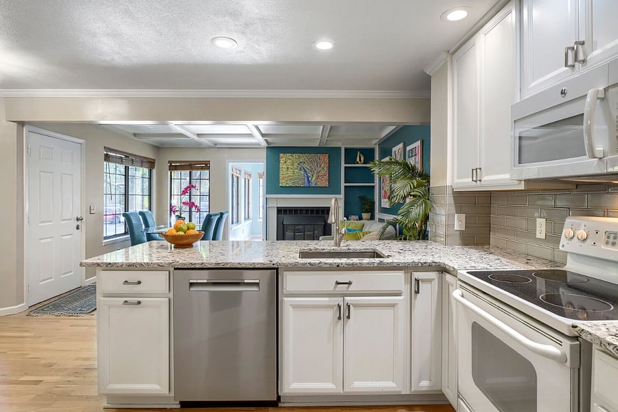 Open-Concept Kitchen, Living & Dining  A thoughtfully designed layout connects the kitchen with the living and dining areas, creating an inviting space for relaxing, dining, and entertaining.