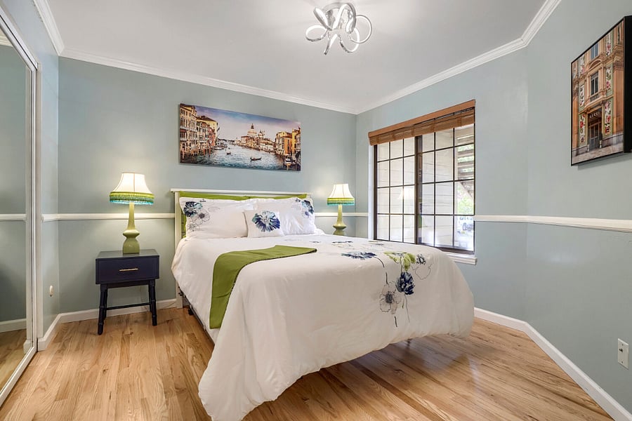 Primary Bedroom  A comfortable, light-filled retreat featuring blackout shades and two full closets with built-in drawers, offering exceptional storage and restful privacy.