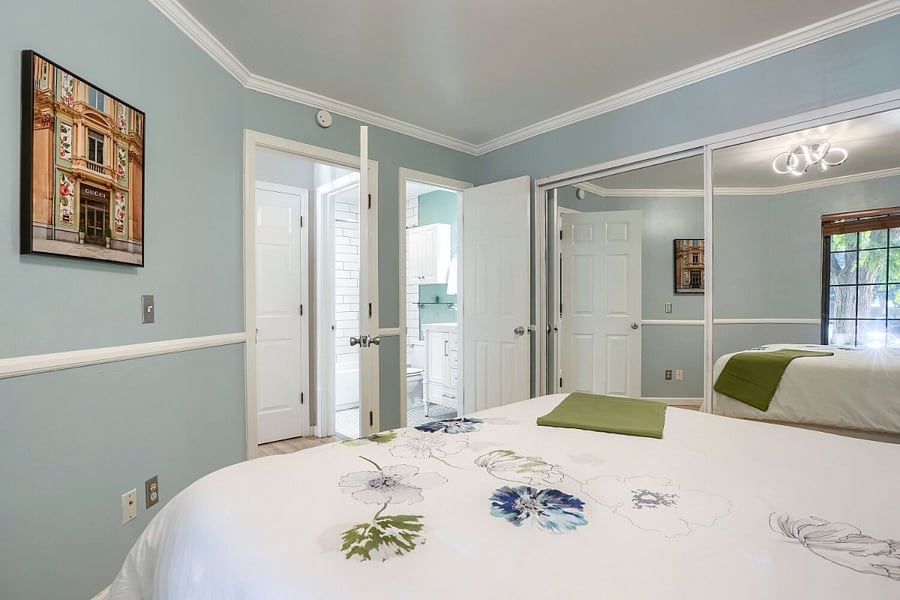 Primary Bedroom with En Suite Bathroom  A comfortable retreat with direct access to the full bathroom and an easy connection to the homes open-concept living, dining, and kitchen areas.