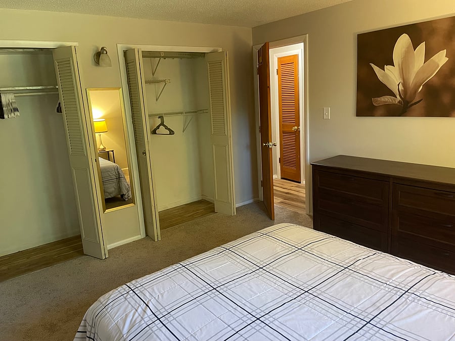 Main floor bedroom 1 showing closets and dresser