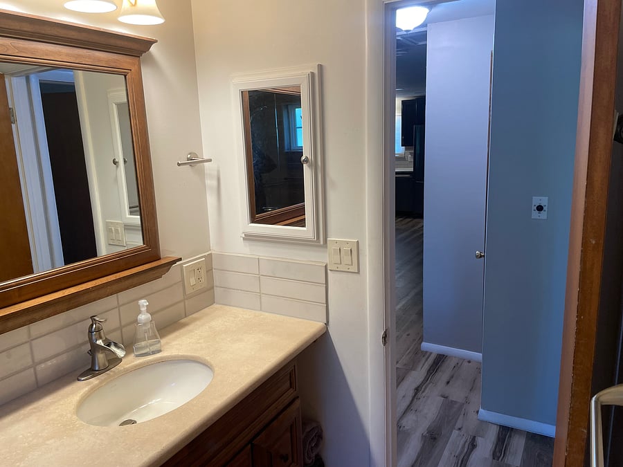 Main floor bathroom with one sink vanity and medicine cabinet