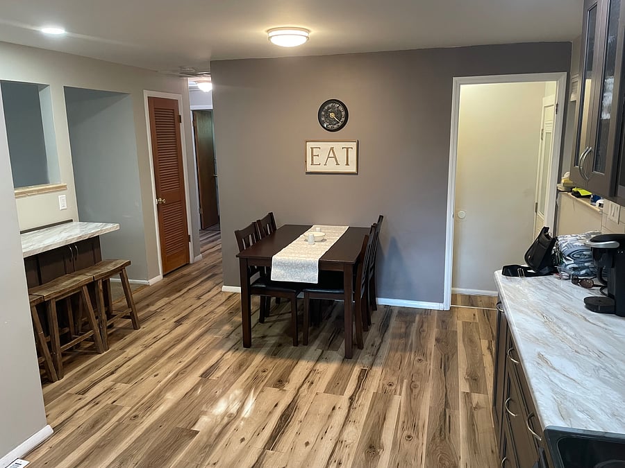 Kitchen with doorway to the left of table leading to two upstairs bedrooms, full bath, pantry and linen closet. Door to right of table leads either downstairs or outside to back porch, yard and garage.