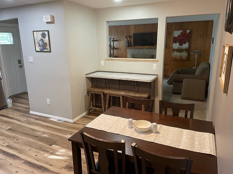 Kitchen table and breakfast nook overseeing living room