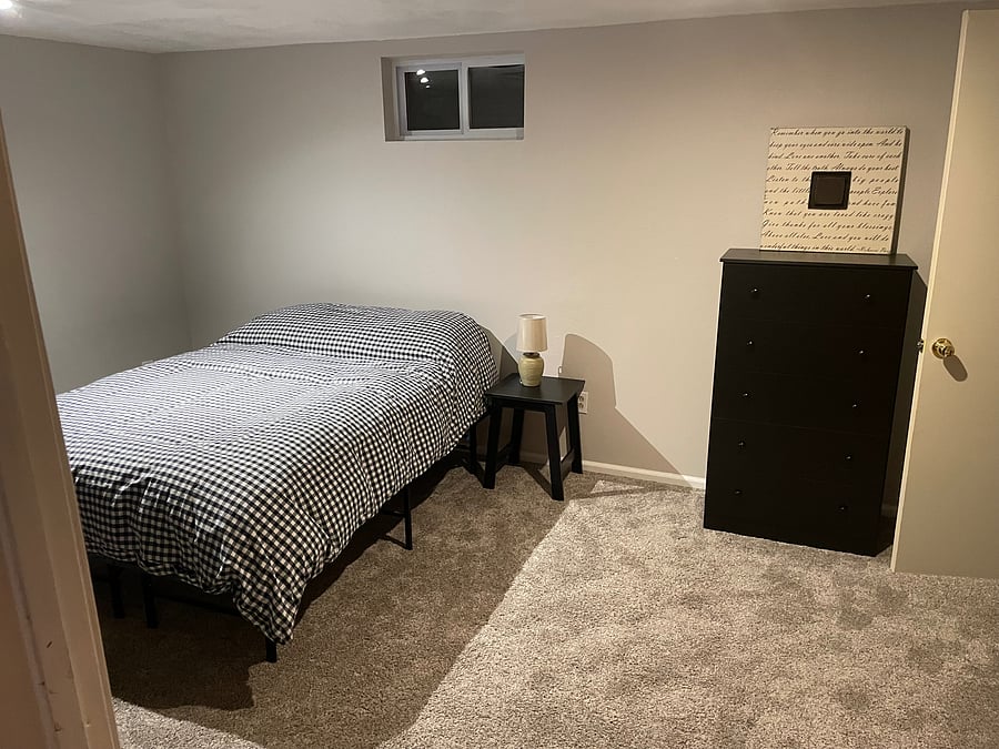 Downstairs bedroom full bed and dresser.