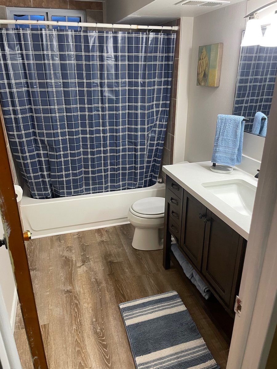 Downstairs bathroom with tub and one sink vanity