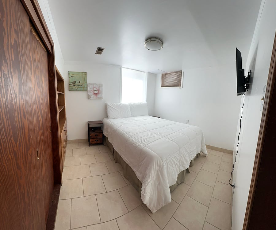 Downstairs bedroom with built in closet and drawers.