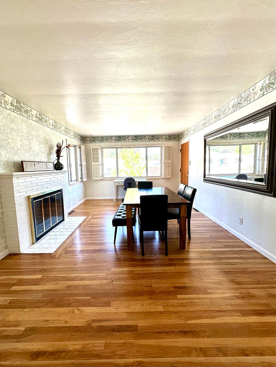 Dining area with wood burning fire place and computer desk. Located on main level.