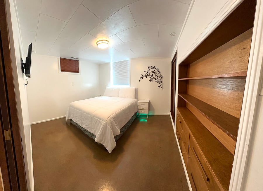 Downstairs bedroom with built in closet and drawers.