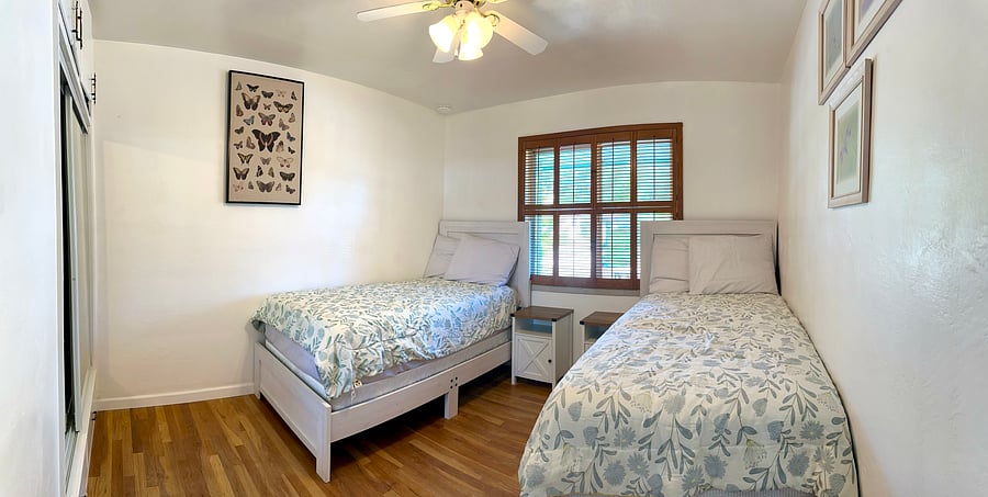 Upstairs second bedroom, two single beds, and closet.