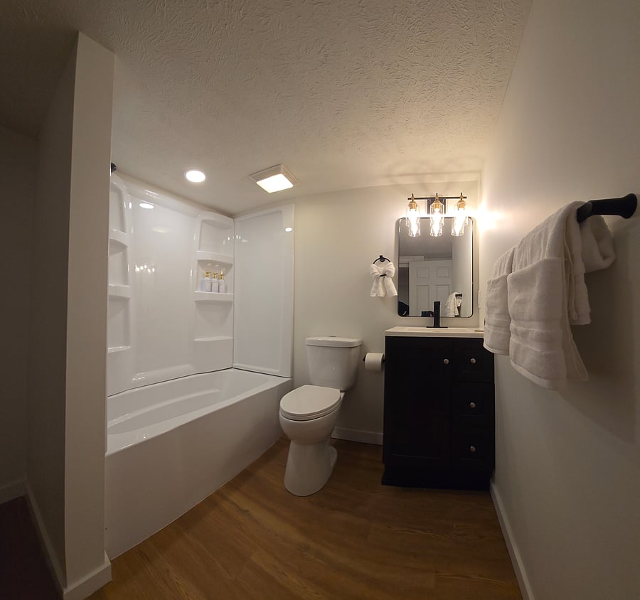 Bathroom # 2 located in the basement, with full bath tub shower combo, sink, toilet. Next to this room there is a laundry area with washer and dryer, iron and iron table.