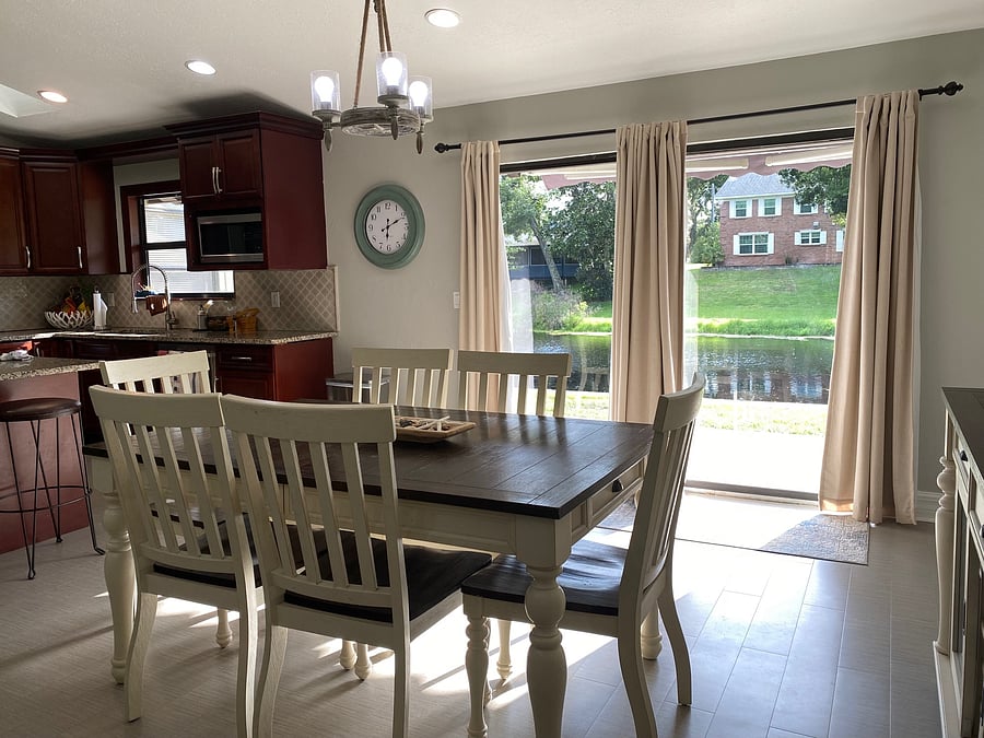 Dining area with curtains drawn, canal in the back