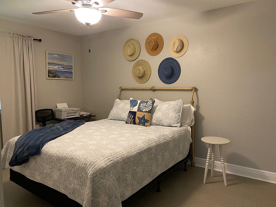 Bedroom with the queen size bed and small work station; know as the Beach room